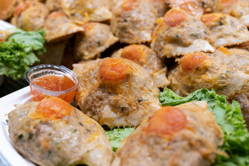 A mix of crab and chicken served inside crab shells with chilli sauce. The shells are filled with a flavorful combination of tender crab meat and succulent chicken,creating a delicious and unique dish