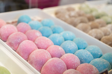 Close-up view of the colouful mochi selling at the bakery shop.
