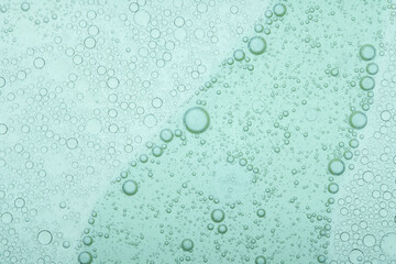 Macro microscope green bubble texture, Close-up Green bubbles and drops oil background . blue green water bubbles, close up golden oil drop for cosmetic...