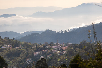 Fototapeta premium Beautiful panoramic view of Kodaikanal's hills with clouds and small villages in the landscape
