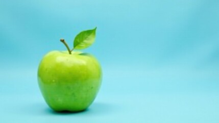 A Single Green Apple with Leaf on a Light Blue Background, Representing Freshness and Health