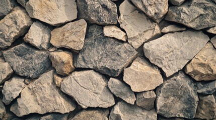 Fototapeta premium Natural stone wall constructed with various sized rocks providing an earthy texture and rustic appearance in a natural setting