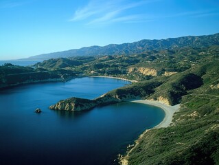 Panoramic view of a mountainous coastal beachfront in California, USA. Clear blue waters meet the rocky shoreline. A picturesque travel destination for outdoor enthusiasts.