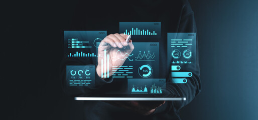 Digital data visualization with hand interacting with futuristic holographic charts and graphs on dark background.