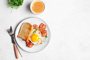 Breakfast sandwich  with fried egg, bacon and sprouts