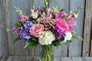Bright flower arrangement in vase showcasing various blooms and colors in a sunny indoor setting