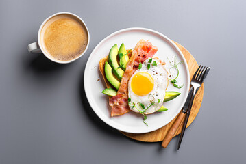 Toast with fried egg, bacon and avocado for breakfast
