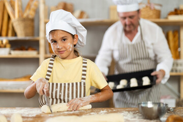 Dad and daughter cook croissants together, cut dough and have nice time