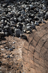 Stone oven in the ground for cooking maguey in an artisanal Mezcal palenque in Oaxaca, Mexico.