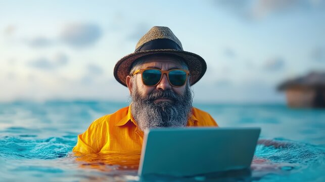 Man in hat and sunglasses using laptop with senior gentleman wearing sunglasses in outdoor setting