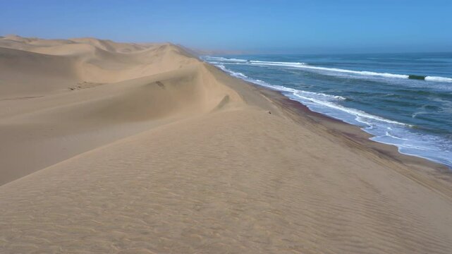 Pan on the Namib Desert meeting the Atlantic Ocean in the Skeleton Coast near Sandwich Harbour in Namibia, Africa.