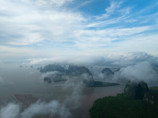 Aerial view drone shot of mountains tropical rainforest with clouds over sea
