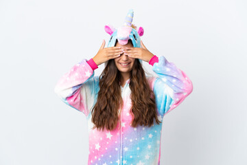 Young caucasian woman wearing a unicorn pajama isolated on white background covering eyes by hands