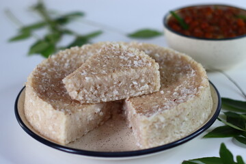 Paputtu or Paal Puttu made with matta rice, a Kerala brown rice, served with chickpea or Kadala masala curry.