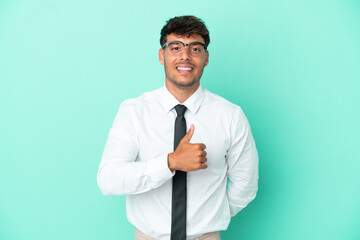 Business caucasian man isolated on blue background giving a thumbs up gesture