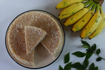 Paputtu or Paal Puttu made with matta rice, a Kerala brown rice, served with chickpea curry and plantain