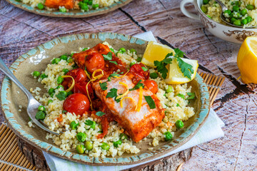 Harissa salmon with bulgur wheat, cherry tomatoes and green peas