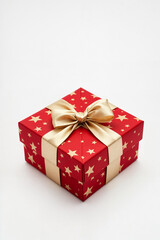 A luxurious red gift box adorned with a golden satin ribbon and festive star pattern, creating a perfect Christmas or holiday present. This elegant and sophisticated packaging is ideal for special occ