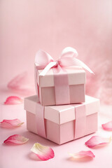 A romantic and elegant pink gift box adorned with delicate white ribbons and scattered rose petals, creating a dreamy, feminine, and luxurious aesthetic. Perfect for weddings, anniversaries, Valentine