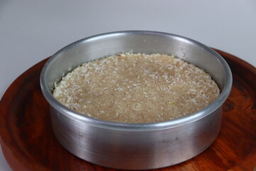 Paputtu or Paal Puttu inside the baking tray, made with matta rice, a Kerala brown rice