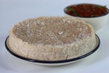 Paputtu or Paal Puttu made with matta rice, a Kerala brown rice, served with chickpea or Kadala masala curry.