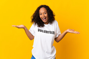 Teenager cuban volunteer girl isolated on yellow background with shocked facial expression