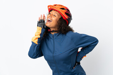 Teenager cyclist woman isolated on white background shouting with mouth wide open to the side