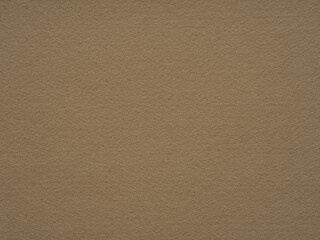 A caramel-colored felt surface presents a rich texture that beckons with its earthy and inviting warmth