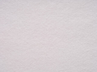 A serene expanse of soft white felt, this image whispers calmness with its subtle texture and pure simplicity