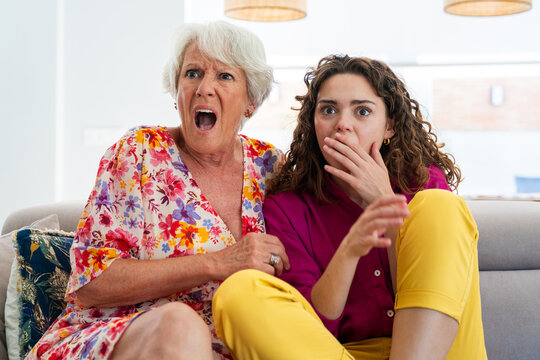 Beautiful grandmother and granddaughter together at home - Cheerful granma and nephew spending quality time together