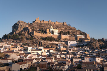 Old Spanish town with big fortified castle on hill top on sunny day, Moclin, Andalusia, Spain