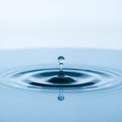 Water droplet creating ripples in a serene blue environment, showcasing tranquility and fluid dynamics