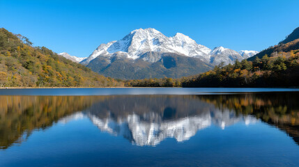 Fototapeta premium Autumn lake reflecting snowy mountain