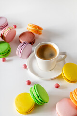 A comforting cup of coffee beside an assortment of macarons, creating an inviting scene perfect for a cozy afternoon