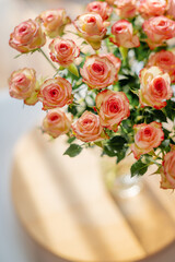 A stunning bouquet of soft pink roses, elegantly displayed in a glass vase, bringing a fresh and romantic touch to any setting