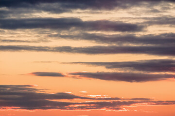 clouds on the sky at sunset. orange sundown. dramatic background in evening light. air pressure