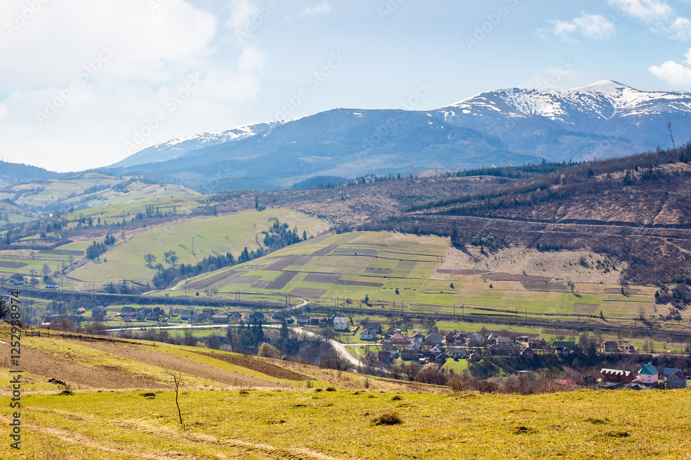 Wall mural carpathian countryside scenery with fields on the hills and village in the valley. beautiful view. m