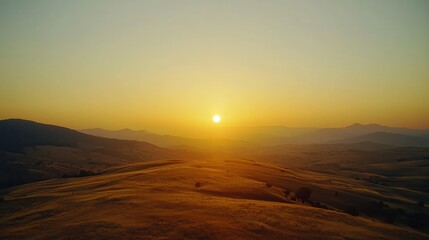 Serene Sunrise Over Rolling Hills with Golden Light and Shadows