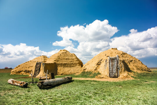 Arkaim in the southern Urals in Russia. ancient dwelling. Three small houses are in the middle of a field