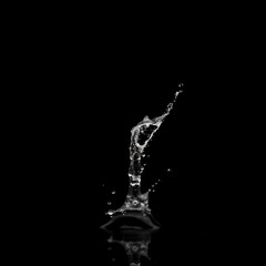 Dynamic water splash captured against a black backdrop, showcasing fluid motion and elegance