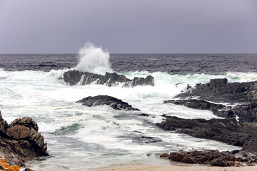 Large Indian Ocean waves and rocky coastline in Tsitsikamma, Garden Route National Park, Eastern Cape. South Africa	