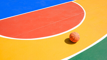Colorful pattern of outdoors basketball court with basketball on concrete floor surface, sport...