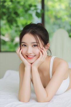 Young asian woman resting in white top with fresh green background
