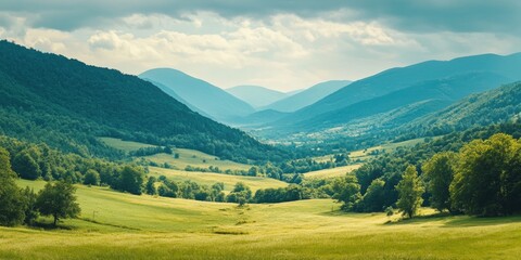 Fototapeta premium Peaceful mountain valley scene with rolling hills, lush greenery and a clear blue sky