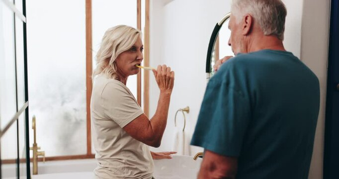 Bathroom, morning and mature couple with toothbrush for oral hygiene, fresh breath and getting ready. Health, man and woman brushing teeth together for dental care, cleaning and grooming in home