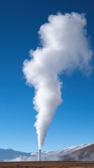 A towering plume of steam rises against a clear blue sky, showcasing the power of geothermal energy