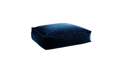 A soft velvet floor cushion in a deep blue shade on a empty plain background
