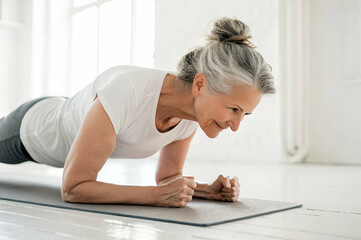 Exercise Routine for Beginners, Senior Woman Doing Plank Exercise On Mat Using Fitness Routine At Home Using