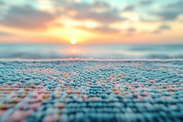 Fototapeta premium Close-up of textured fabric with a blurred sunset ocean backdrop.