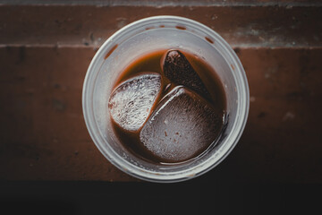Plastic cup of iced chocolate drink seen from above